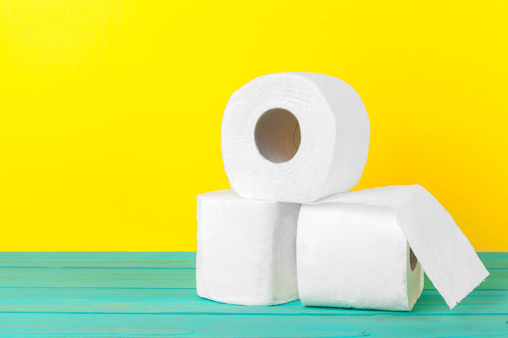 Toilet paper stacks  on bright yellow background - Photo, Image