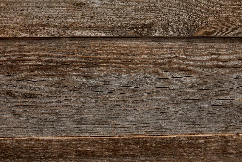 bovenaanzicht van verweerde bruin getextureerde houten achtergrond - Foto, afbeelding