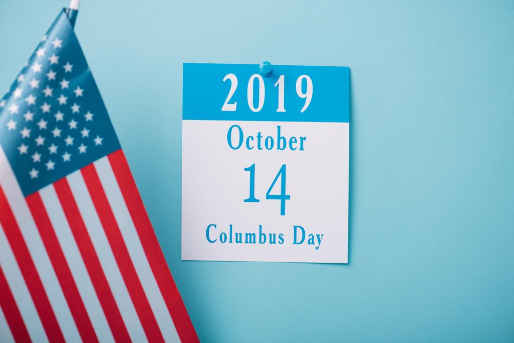 calendrier en papier avec inscription Columbus Day près du drapeau national américain sur fond bleu
 - Photo, image