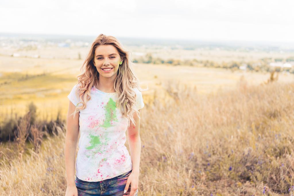 attractive woman in t-shirt smiling and looking at camera  - Photo, Image