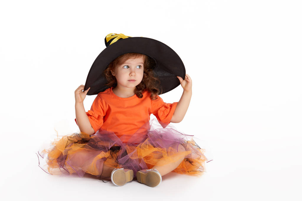 Happy Halloween party. Funny child girl in witch costume for Halloween on white isolated background. trick or treat - Photo, Image