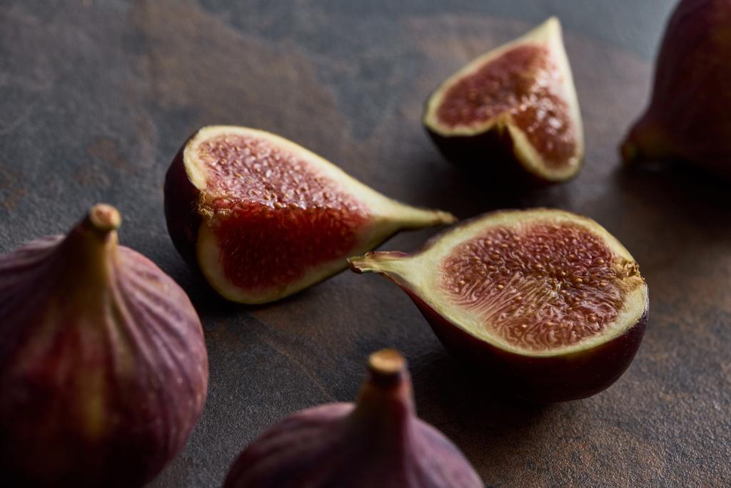 ripe whole and cut delicious figs on stone background - Photo, Image