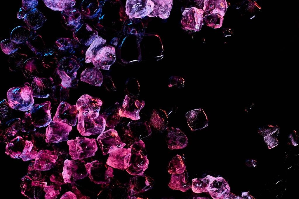 top view of frozen ice cubes with purple lighting isolated on black - Photo, Image