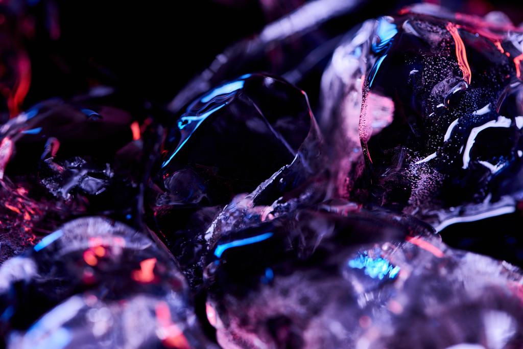 close up view of ice cubes with purple illumination isolated on black - Photo, Image