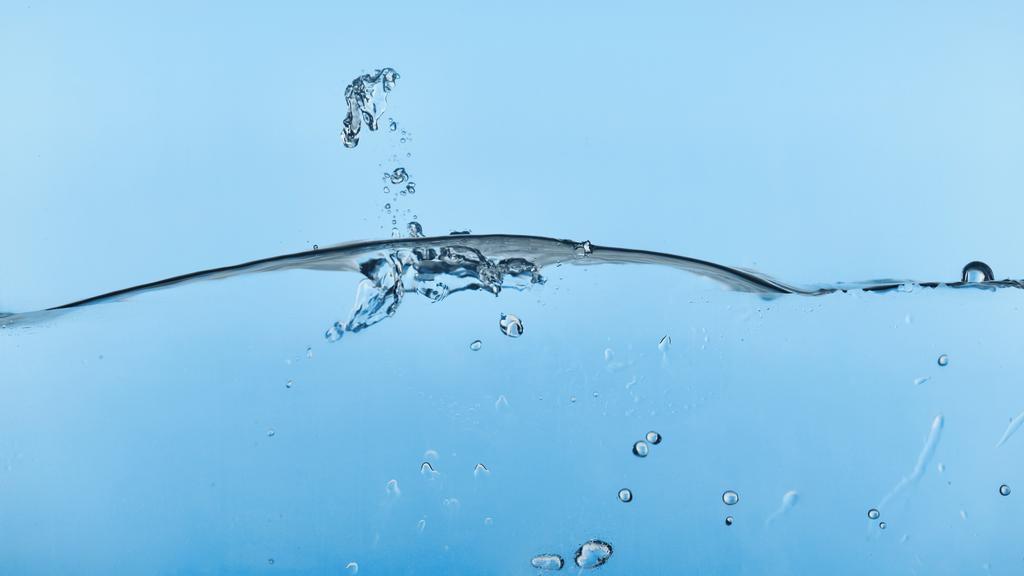 wavy transparent water on blue background with splash - Photo, Image