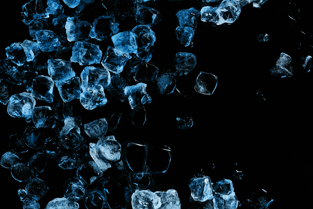 top view of frozen ice cubes with blue light isolated on black - Photo, Image