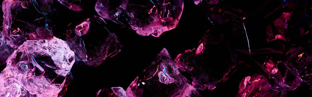 panoramic shot of transparent ice cubes with purple light isolated on black - Photo, Image