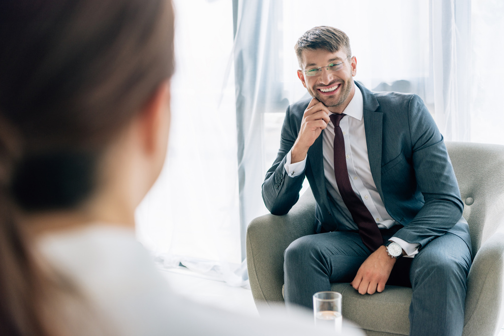 enfoque selectivo de periodista hablando con hombre de negocios guapo en traje y gafas
  - Foto, Imagen