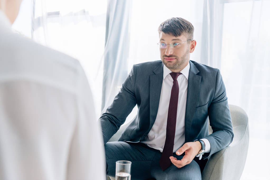 избирательное внимание привлекательного бизнесмена в костюмах и очках, беседующего с журналистом
  - Фото, изображение