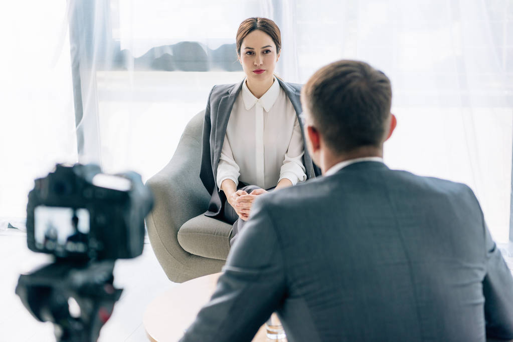 selective focus of attractive journalist talking with businessman in suit  - Photo, Image