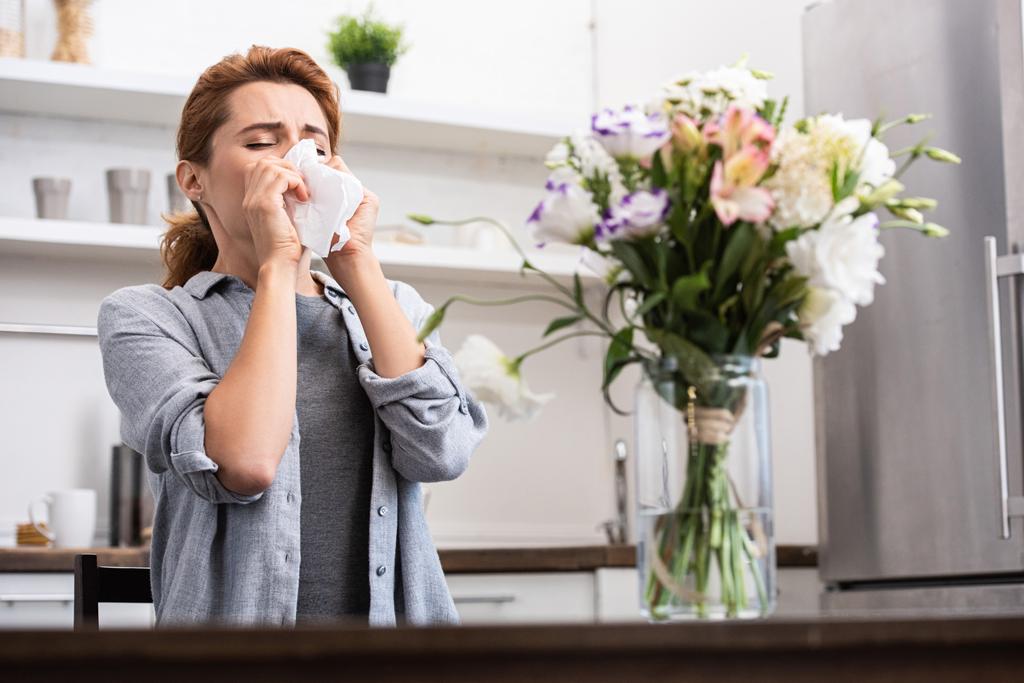 valikoiva painopiste naisen siitepöly allergia aivastelu kudoksessa lähellä kukkia
  - Valokuva, kuva