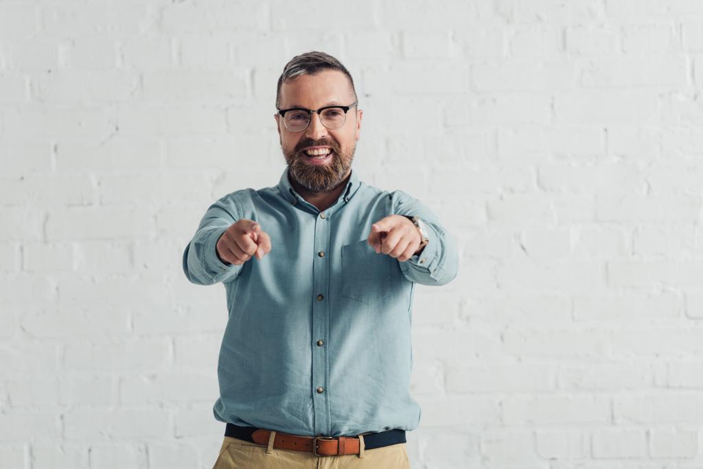handsome and smiling businessman in shirt pointing with finger  - Photo, Image