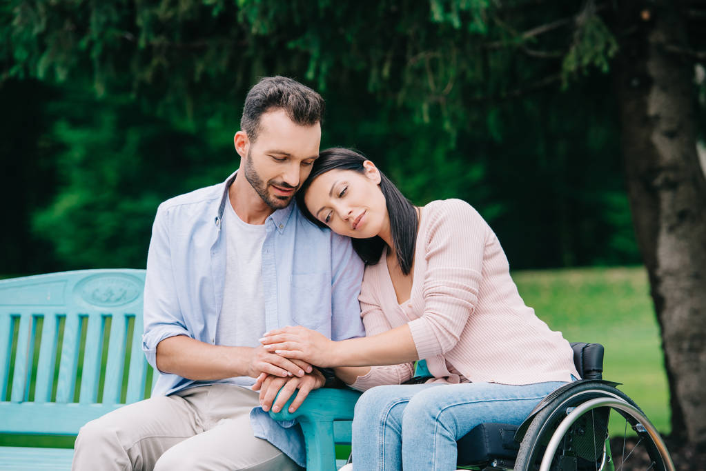 happy disabled woman with smiling handsome boyfriend resting in park together - Photo, Image