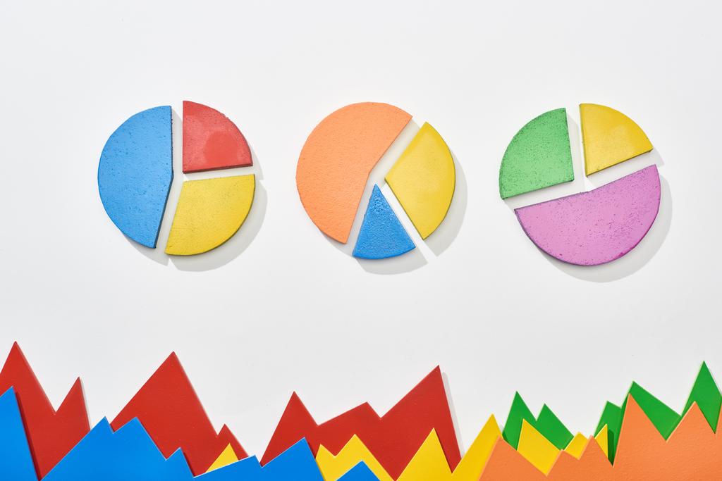top view of multicolor statistic graphs and pie charts on white background - Photo, Image