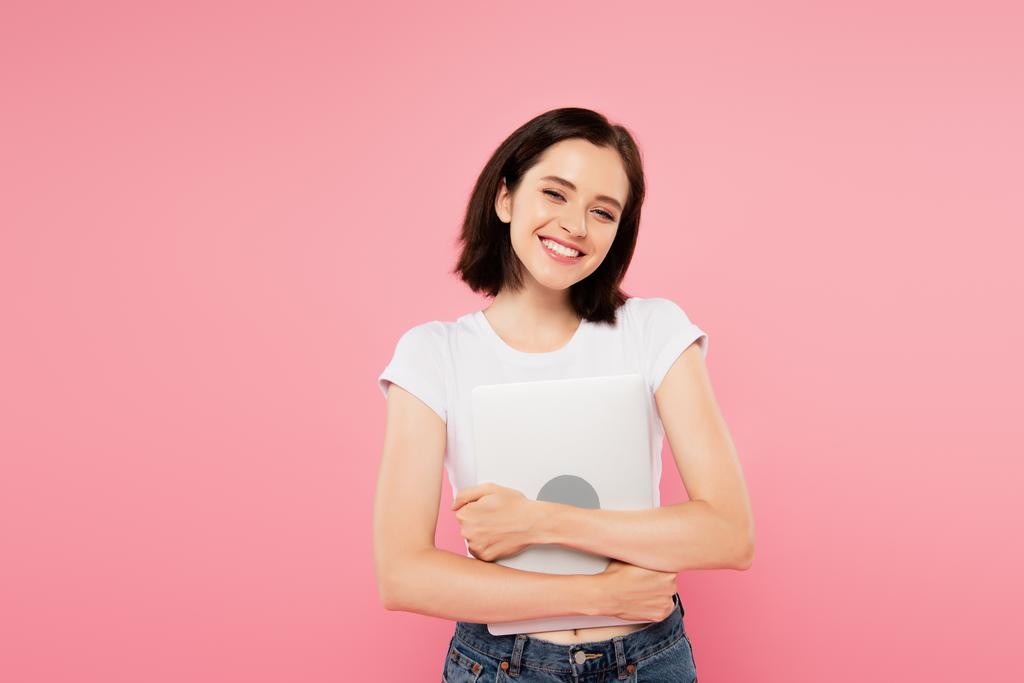 smiling pretty girl holding laptop isolated on pink - Photo, Image