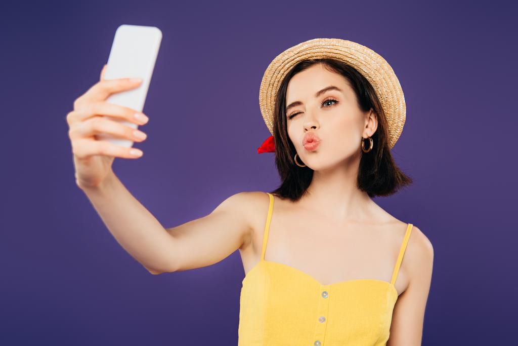 hymyilevä tyttö olki hattu mököttää huulet ottaen selfie älypuhelimeen eristetty violetti
 - Valokuva, kuva