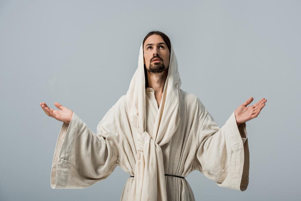człowiek religijny w Jezusa szatę z kapturem i wyciągnięte ręce izolowane na szaro - Zdjęcie, obraz