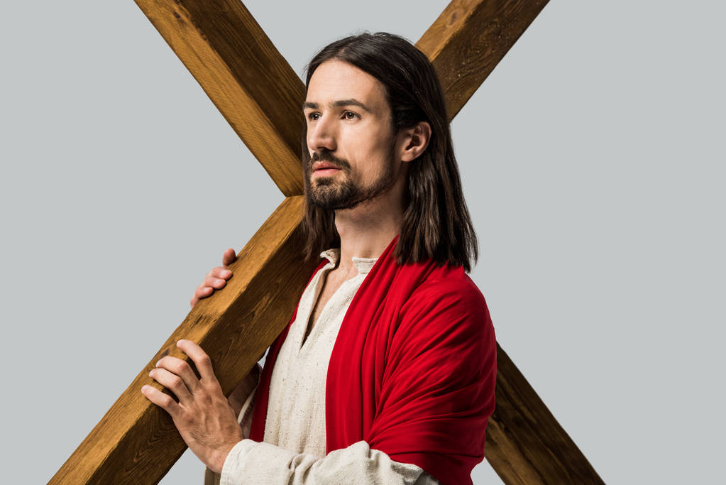 Ježíš držící dřevěné kříže izolované na šedé  - Fotografie, Obrázek