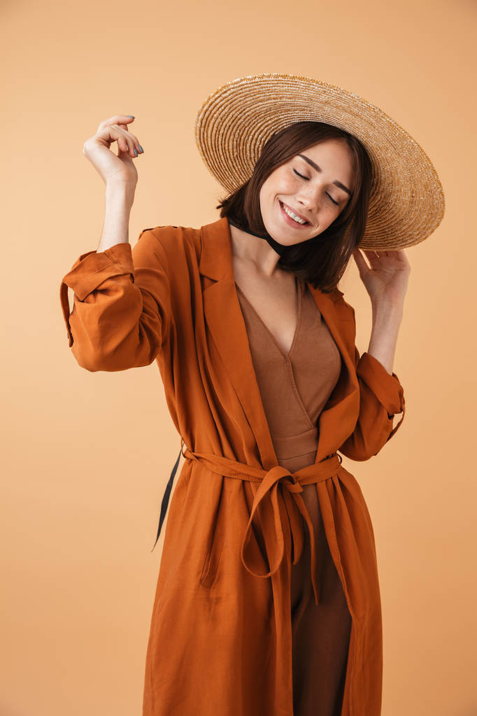 Portrait of a beautiful young woman wearing straw hat - Photo, Image