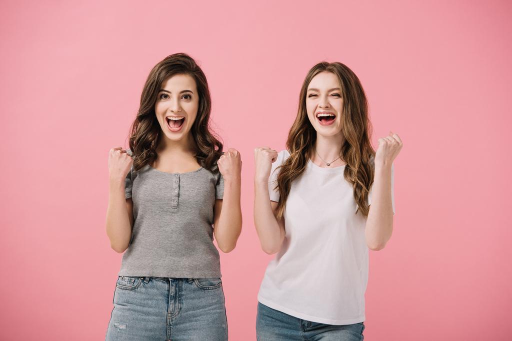 привабливі і шоковані жінки в футболках дивляться на камеру і показують так жести ізольовані на рожевому
 - Фото, зображення
