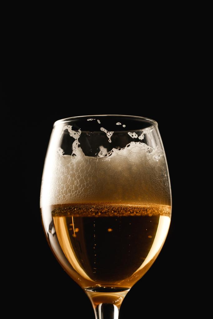 glass of beer with white foam isolated on black - Photo, Image