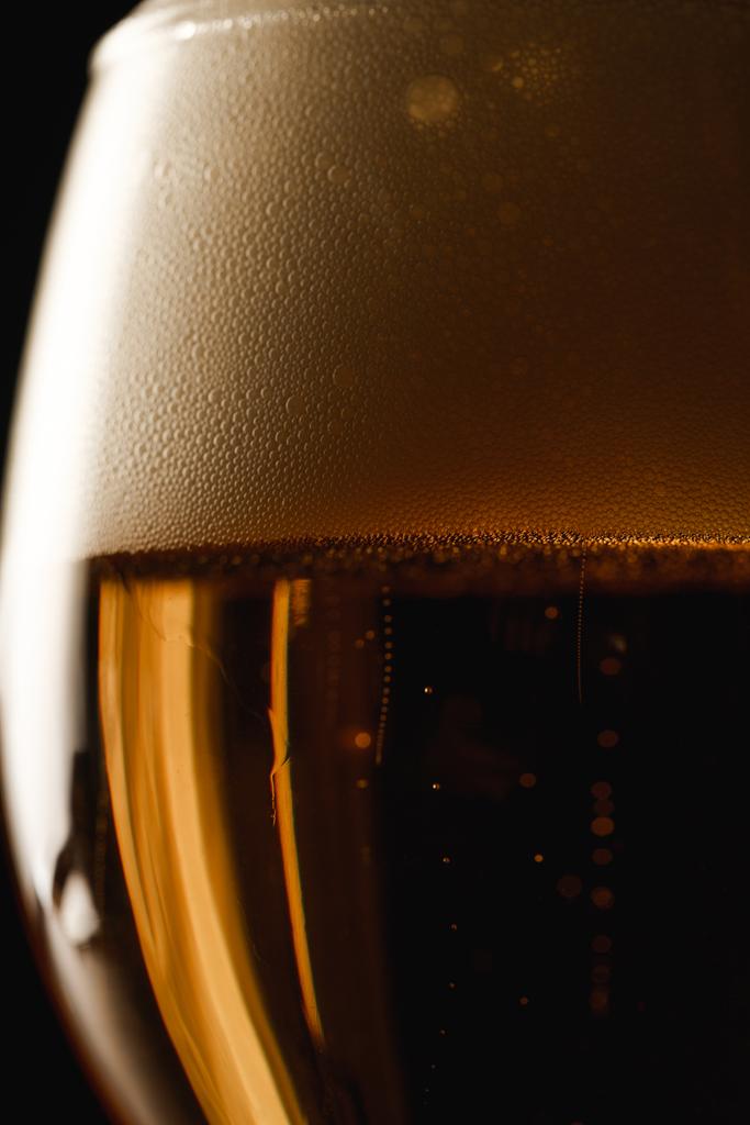 close up view of beer with foam isolated on black - Photo, Image