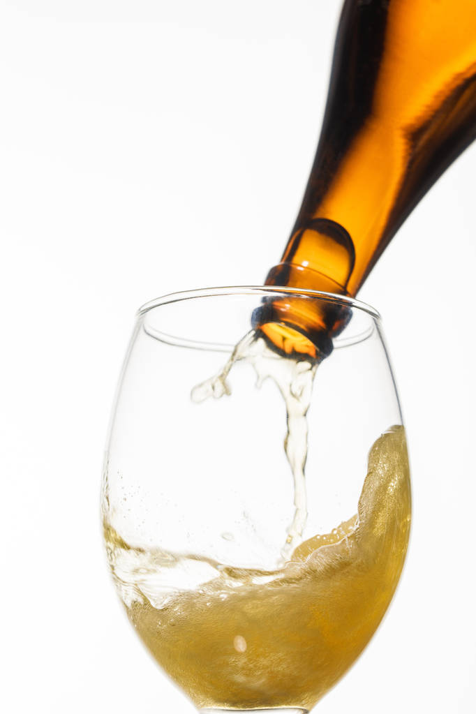 beer pouring from bottle into glass with splash isolated on white - Photo, Image
