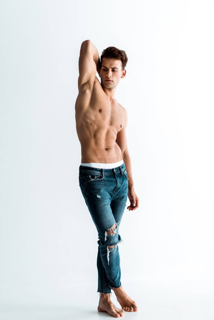 sexy man with barefoot standing in jeans on white  - Photo, Image