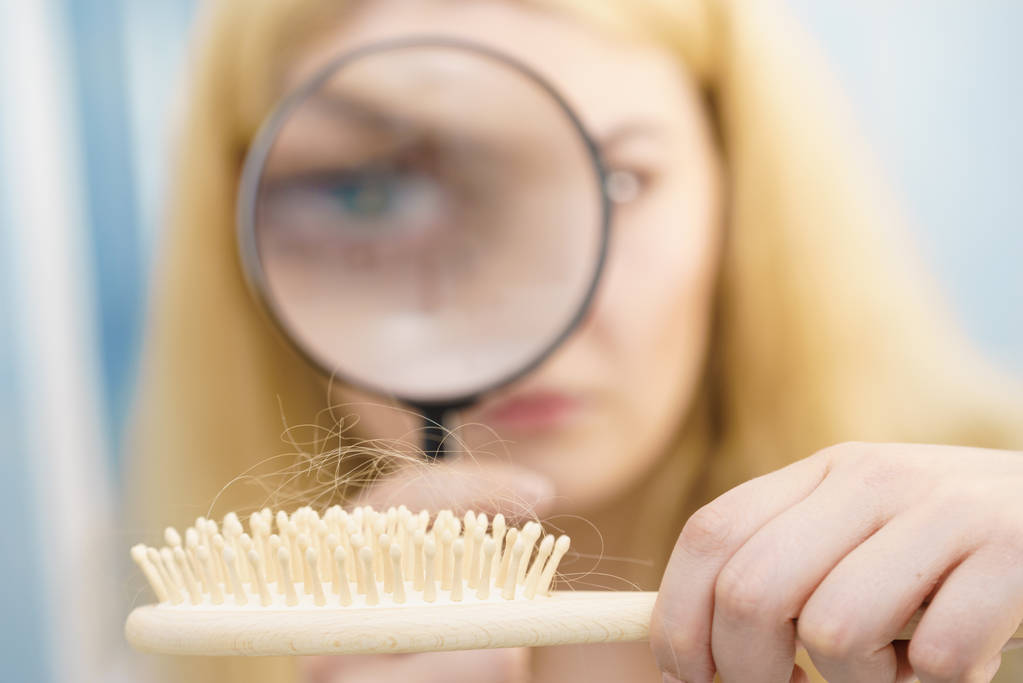Woman magnifying hair brush - Photo, Image