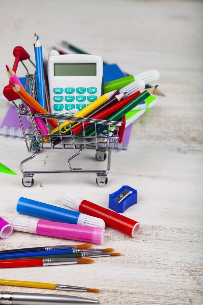 Items for school in a shopping cart. - Photo, Image