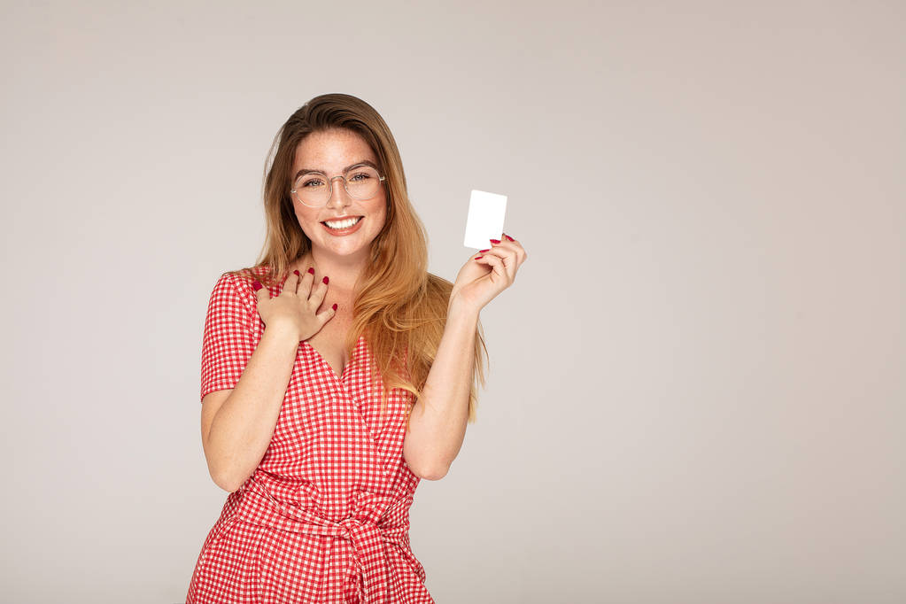 Redhead young woman with credit bank card. - Photo, Image