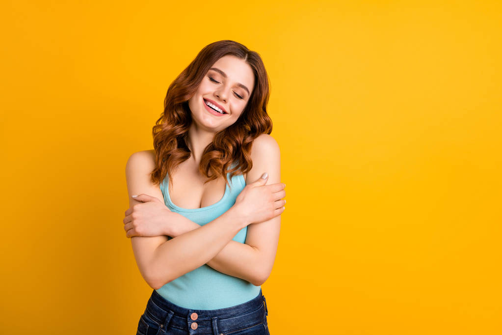 Photo of pretty lady holding hands on shoulders in love with herself wear tank-top isolated yellow background - Photo, Image