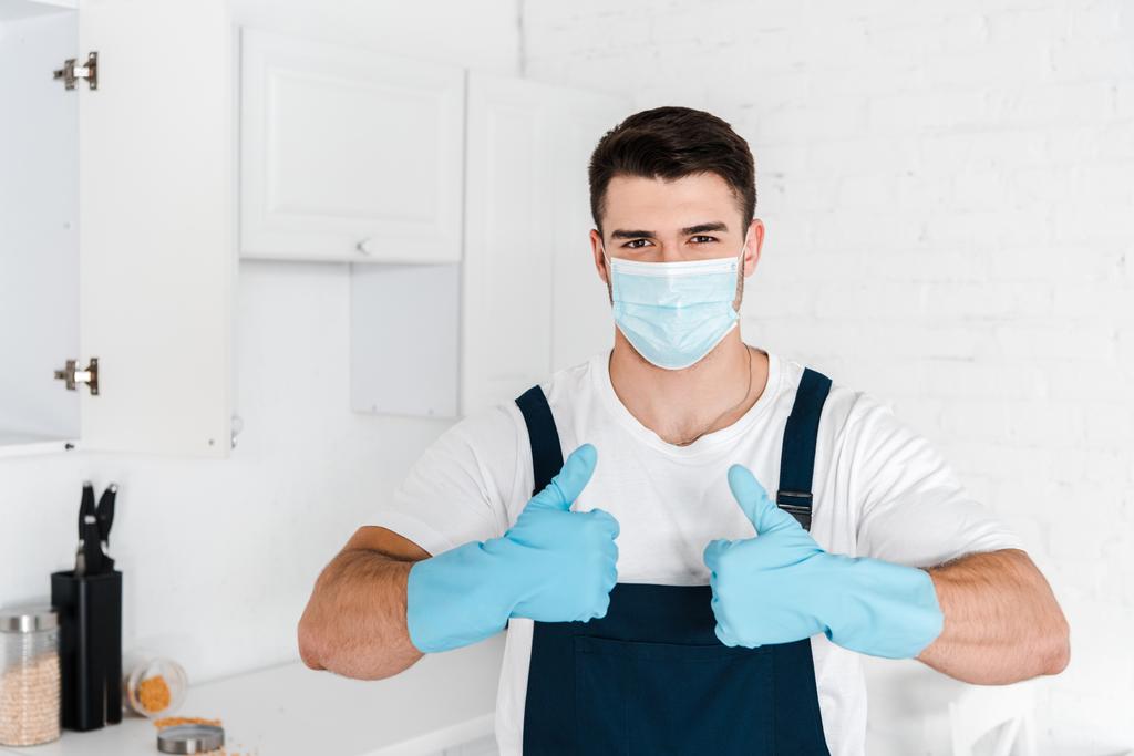 exterminator in blue latex gloves showing thumb up  - Photo, Image