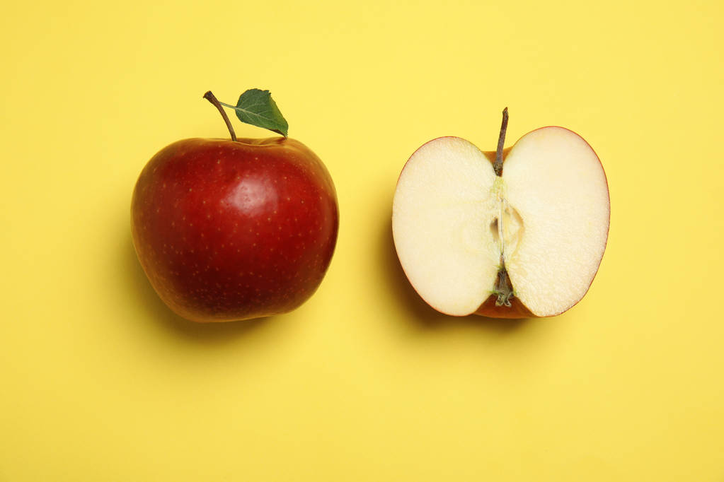 Flat lay composition with ripe juicy red apples on yellow background - Photo, Image