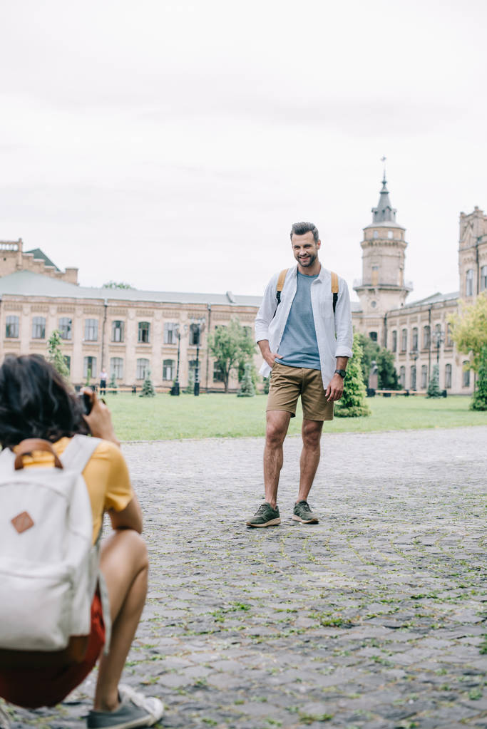 selective focus of happy man standing near girl taking photo  - Photo, Image