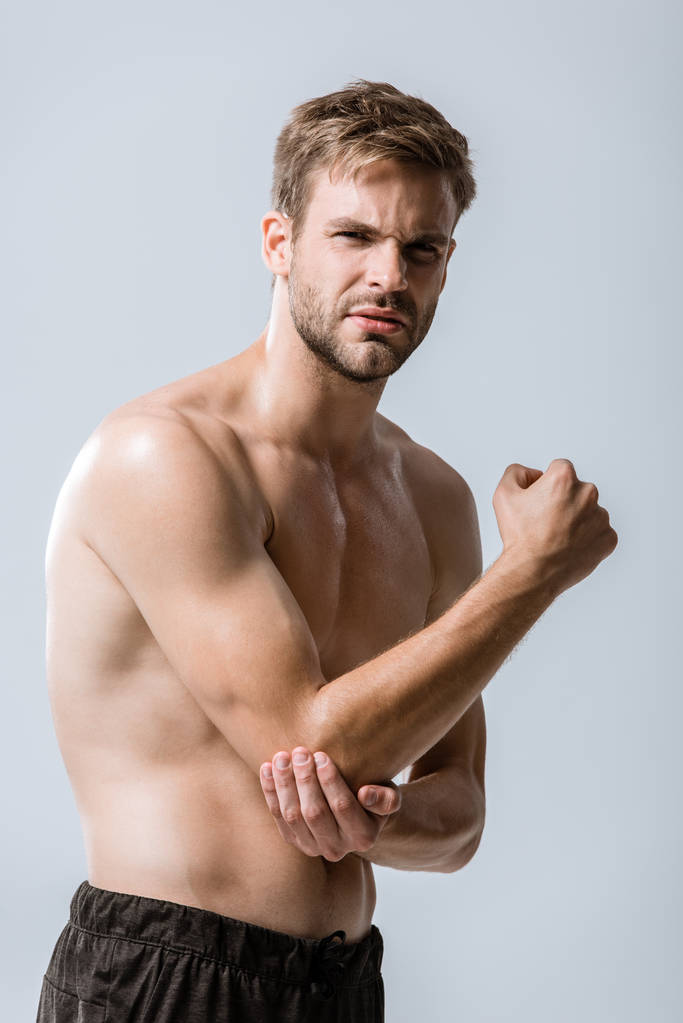 shirtless bearded sportsman with elbow pain isolated on grey - Photo, Image