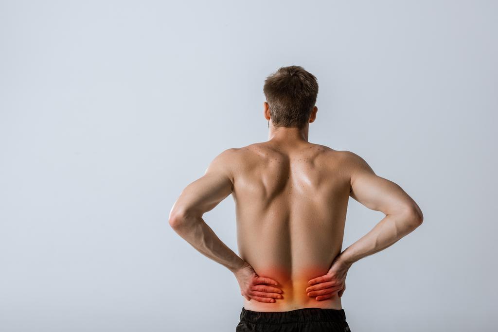 gri izole alt sırt ağrısı ile gömleksiz sporcu nun arka görünümü - Fotoğraf, Görsel