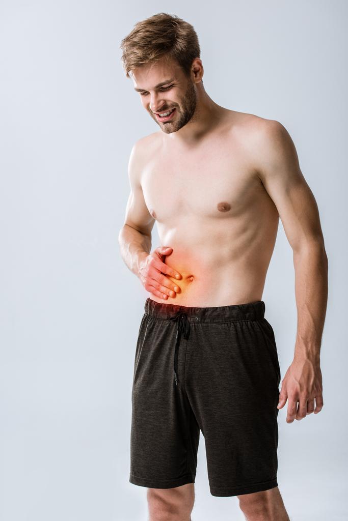 shirtless sportman with abdominal pain isolated on grey - Photo, Image