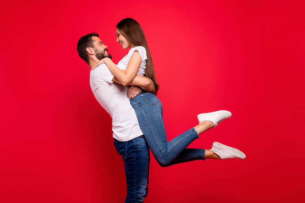 Profile side view portrait of his he her she nice attractive lovely lovable affectionate cheerful careful spouses spending honey moon vacation having fun isolated on bright vivid shine red background - Photo, Image