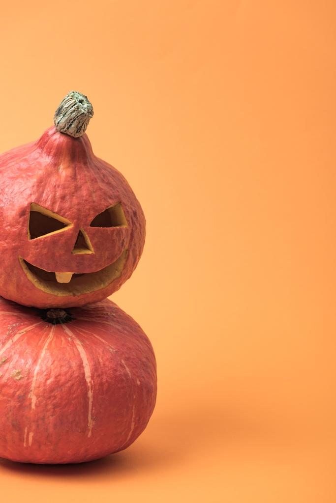 decorative spooky Halloween pumpkins on orange background - Photo, Image