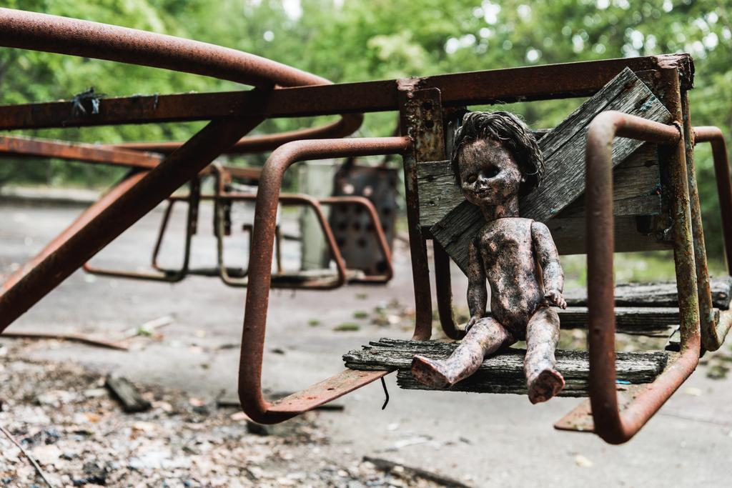wypalona lalka dla niemowląt na opuszczonej karuzeli w Czarnobylu  - Zdjęcie, obraz