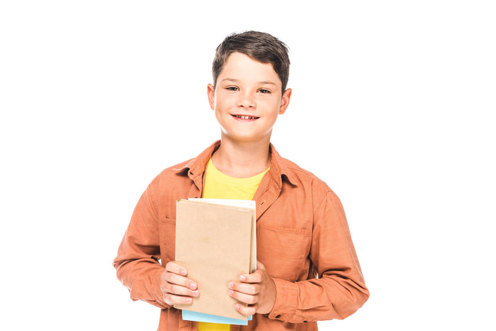 vista frontal del niño sonriente sosteniendo libros aislados en blanco
 - Foto, Imagen