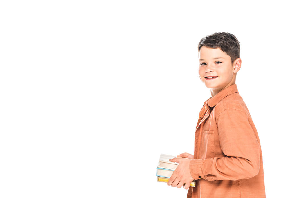 улыбающийся ребенок в рубашке с книгами, изолированными на белом
 - Фото, изображение