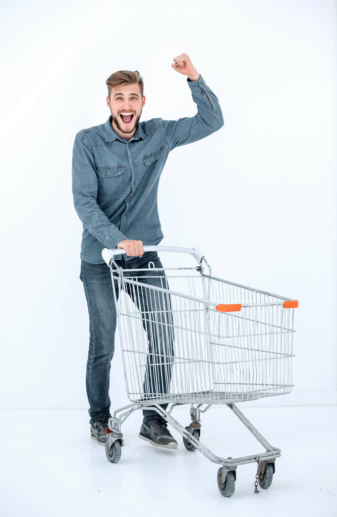Egy boldog ember, egy bevásárló kocsi fut teljes hosszában portréja - Fotó, kép