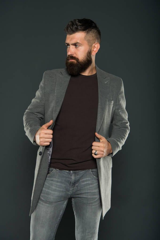 His long beard works well. Bearded man with stylish mustache and beard shape. Unshaven hipster with textured beard hair grey background. Caucasian guy with beard wear casual style - Photo, Image