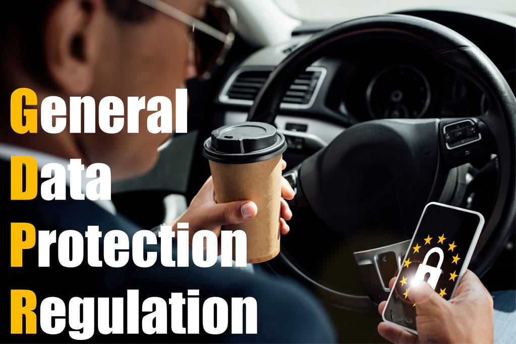 back view of african american businessman using smartphone and drinking coffee in car with gdpr illustration - Photo, Image