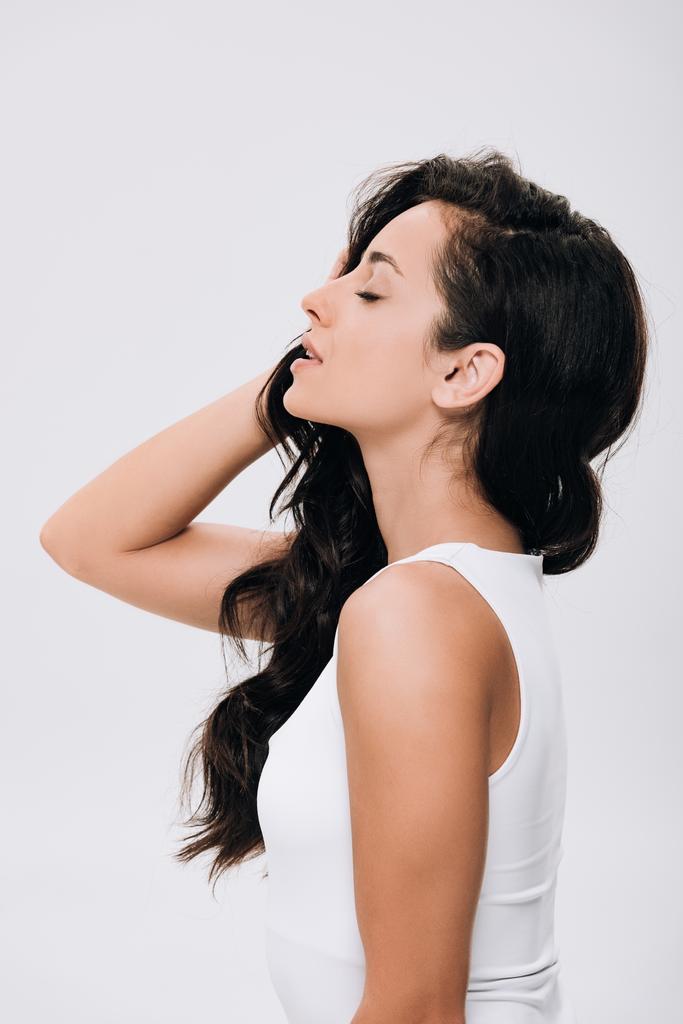side view of brunette beautiful woman with closed eyes and long healthy hair isolated on grey - Photo, Image