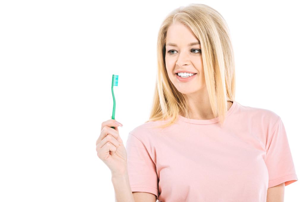 красивая женщина смотрит на зубную щетку изолированы на белом
 - Фото, изображение