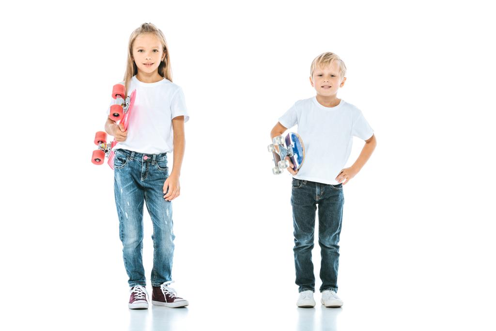 happy kids smiling while holding penny boards on white  - Photo, Image