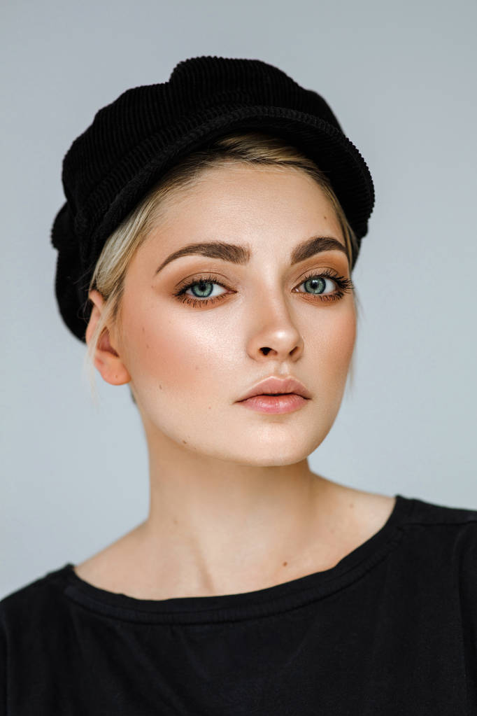 Kosmetický portrét módy mladý model s krátkými vlasy a černou čapkou - Fotografie, Obrázek